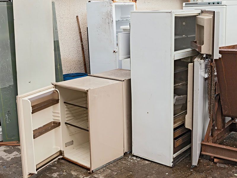 Old refrigerators waiting for appliance removal